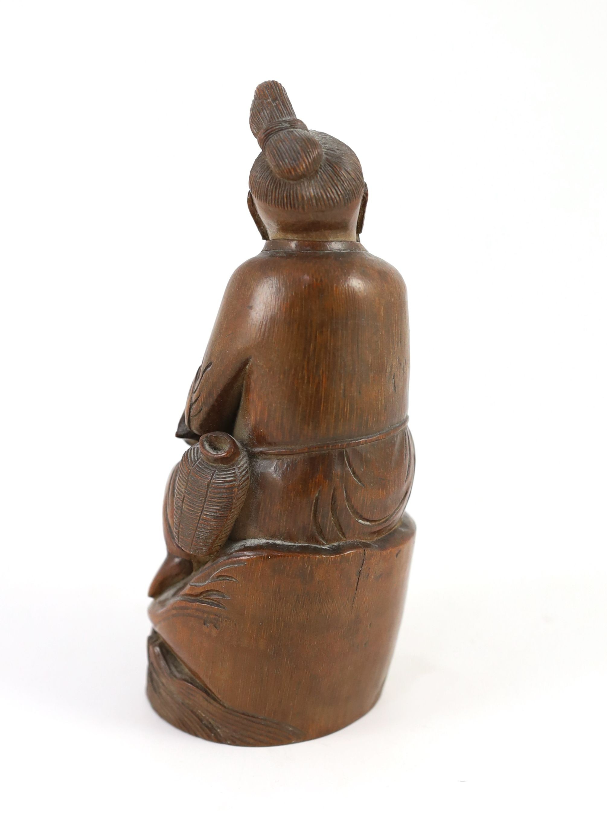 A Chinese bamboo figure of a seated fisherman, 19th century, 16.5 cm high